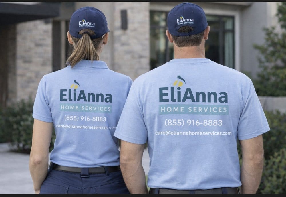 Two EliAnna Home Services crew members in branded uniforms with the company phone number and email printed on their shirts